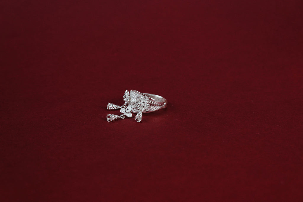 Blossom Chime Filigree Ring – side view showing sculpted flower crown and dangling bell and crystal charms