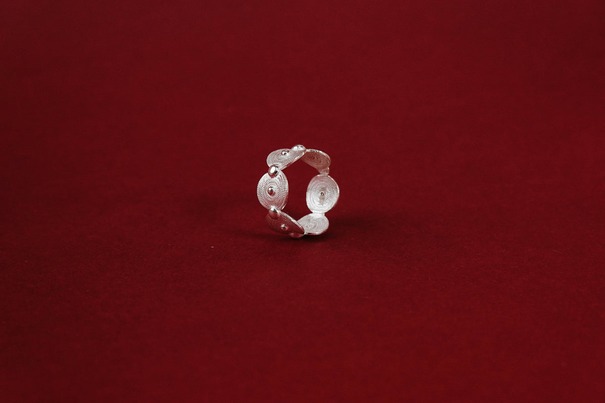 Filigree Swirl Ring – side view showing open-back adjustable band and disc construction
