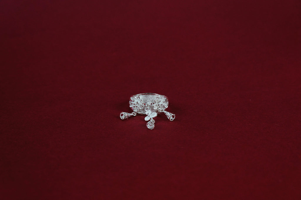 Nuya Ring – top-down view showing five dangling charms spread around the crown