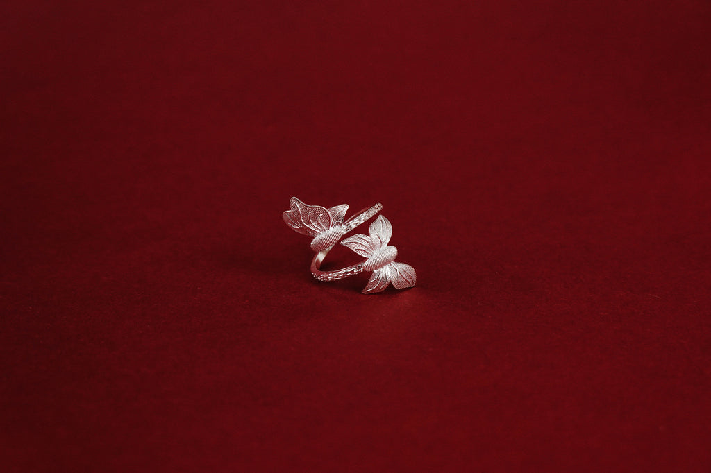 Twin Butterfly Ring – three-quarter view showing full butterfly wrap and twisted rope band detail