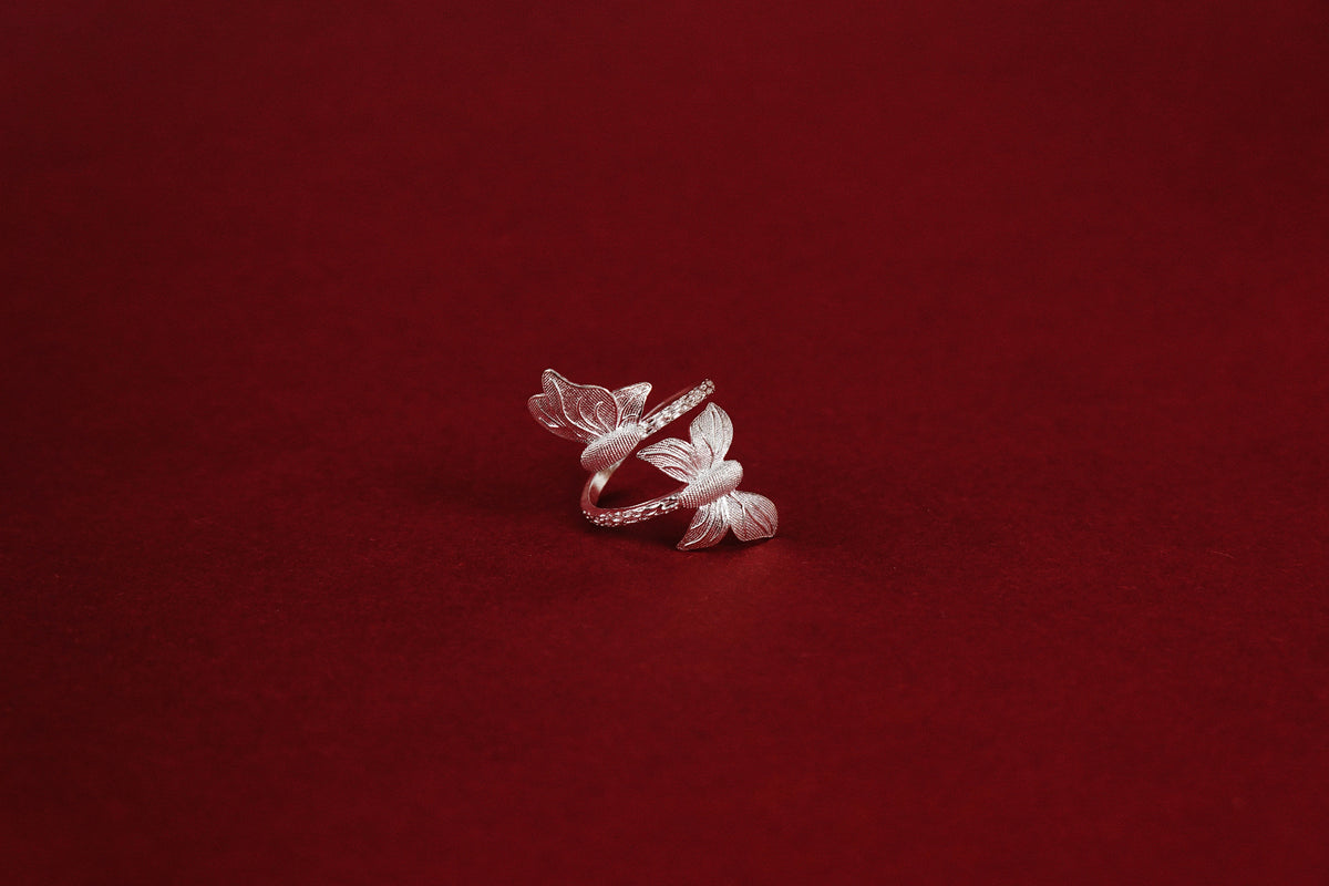Twin Butterfly Ring – three-quarter view showing full butterfly wrap and twisted rope band detail